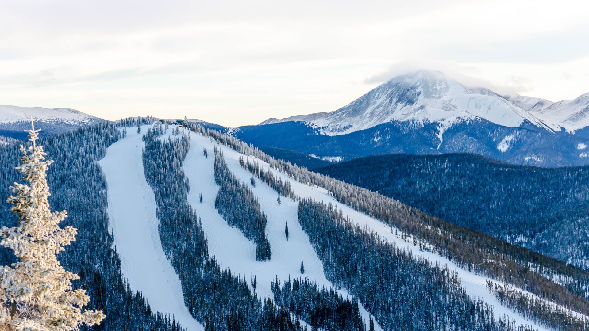 Keystone mountain overlooking ski slopes in a blanket of white snow